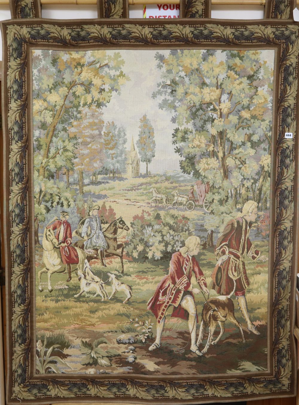 An Aubusson style machine woven hanging tapestry depicting a hunting party, with pole